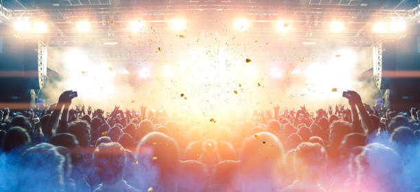 istock Concert stage, people are visible waving and clapping, silhouettes are visible 1203625171
