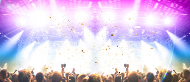 istock Concert stage, people are visible waving and clapping, silhouettes are visible 1203625195