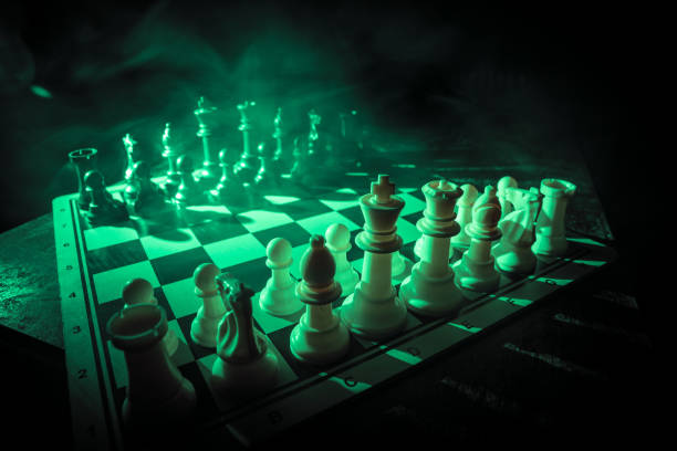 istock Chess figures on a dark background with smoke and fog. Selective focus 1203626349