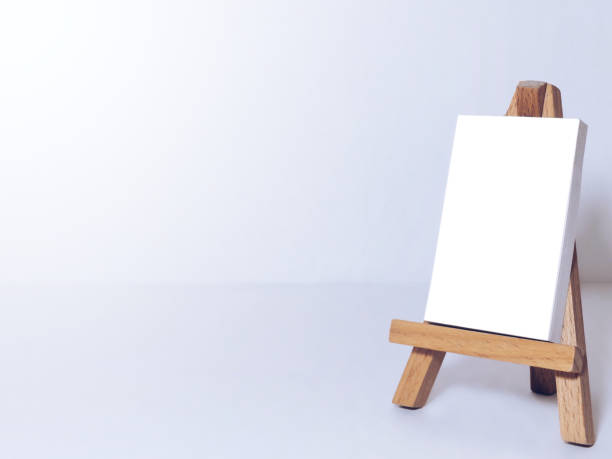 istock Easel for artists and blank canvas miniature 1203626439