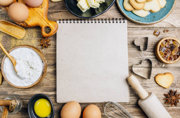 istock Valentine's Day baking culinary background. Ingredients for cooking on wooden kitchen table, baking recipe for pastry. Heart shape cookies. 1203627663