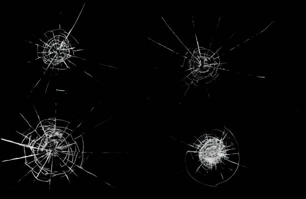 istock Round white cracks in glass on black background. 1203629765