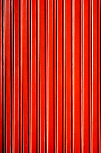 Corrugated metal door painted in red.