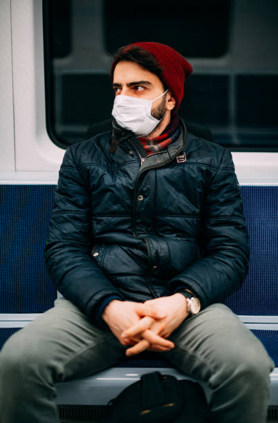 istock Man Wearing a Sterile Mask in the Subway 1203633929