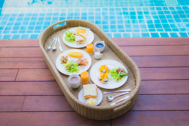 istock Floating breakfast around outdoor swimming pool 1203633945
