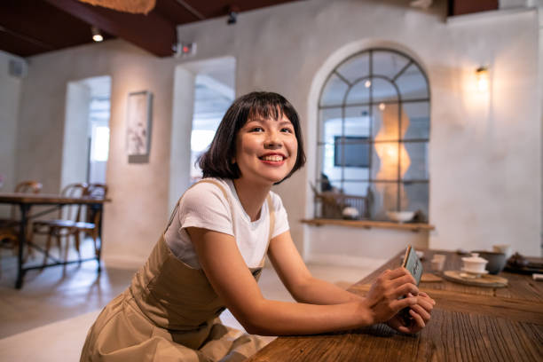 istock Young woman ordering tea at traditional style cafe 1203635072