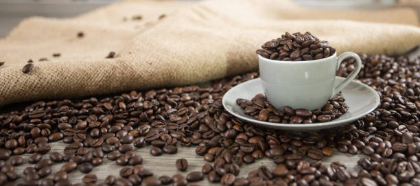 istock Roasted coffee beans in a caffee mug 1203637995