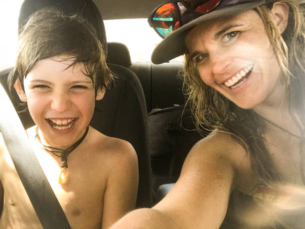 istock Single mom selfies with 10 year old son in a car. 1203642083
