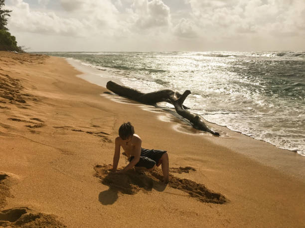 istock Child plays on a. beautiful island beach 1203642084