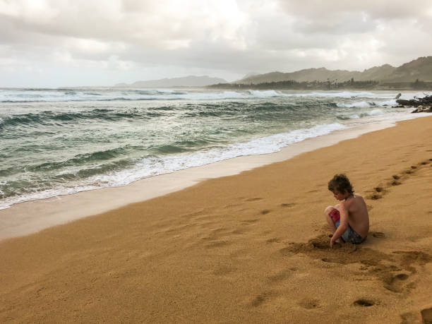istock Child plays on a. beautiful island beach 1203642089