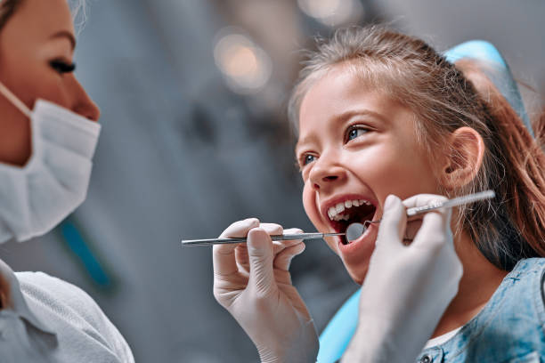Cute little girl in the dentist chair Cute little girl in the dentist chair. Close up view dental hygienist stock pictures, royalty-free photos & images