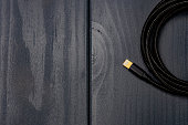 Black braided fabric cable with lightning terminal to connect to electronic devices