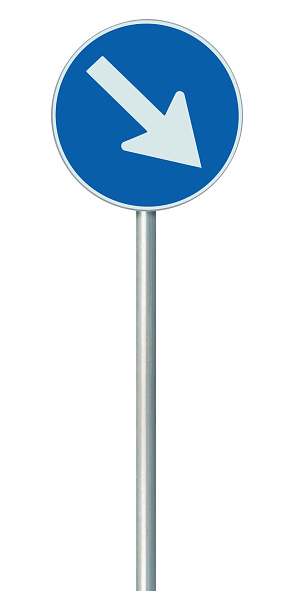 Mandatory keep right European Union EU road sign on pole post, large blue round isolated traffic lane route reroute roadside regulatory warning signage, white arrow, vertical closeup