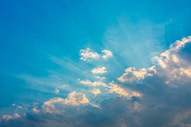 istock blue sky with clouds and sun shines 1203647070