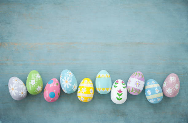 painted easter eggs on a rustic blue wood background - wood eggs easter easter egg imagens e fotografias de stock