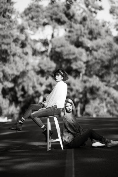 Two young women posing on the road, Black and white composition