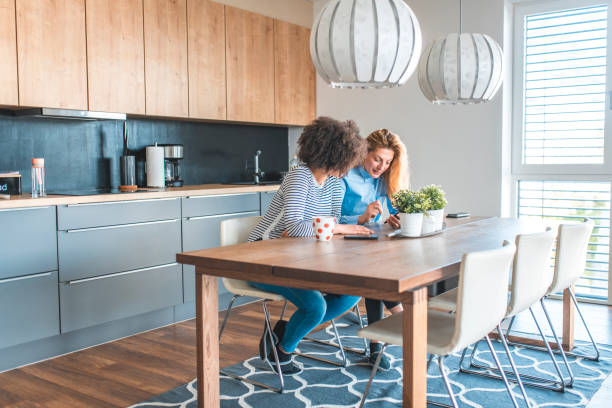 istock Cheerful female friends sitting at dining table 1203655260