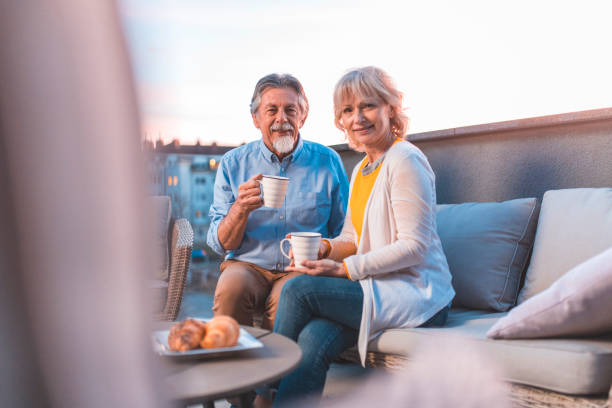 istock Senior couple with coffee at building terrace 1203655270