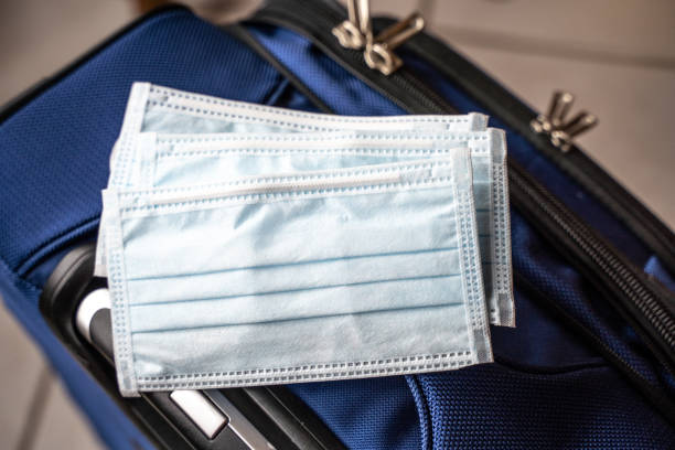 istock Medical Masks on Suitcase to be use when Travel 1203657323