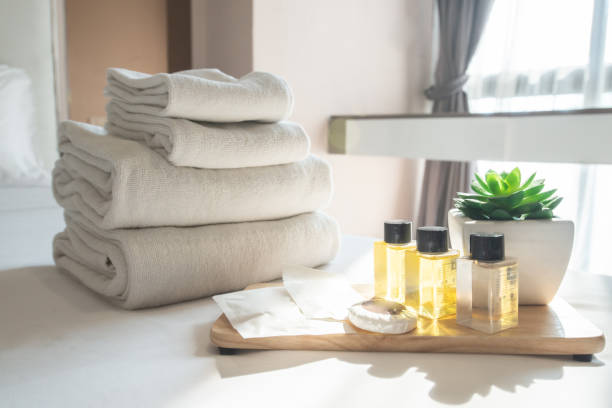 istock Set of hotel amenities (such as towels, shampoo, soap etc) on the bed. 1203658242