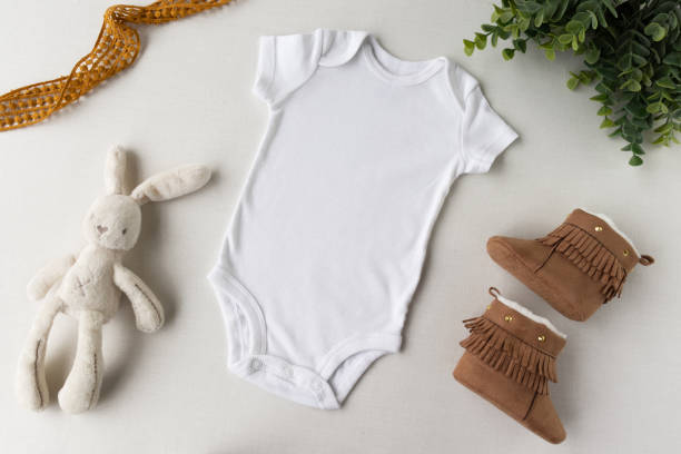 istock Blank white baby bodysuit flat lay mockup - light background 1203663142