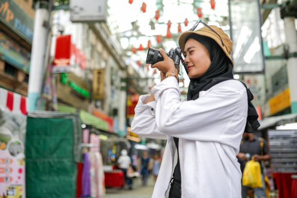 istock Young beautiful tourist travelling and holding map 1203665219
