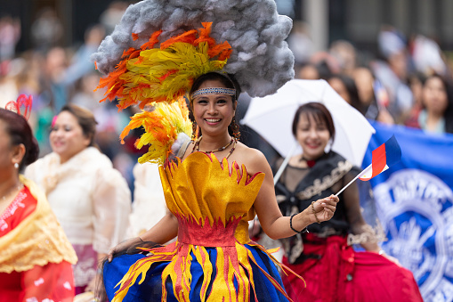 Houston, Texas, USA - November 28, 2019: H-E-B Thanksgiving Day Parade, Members of the Filipino community in Houston walking down Milam street during the parade