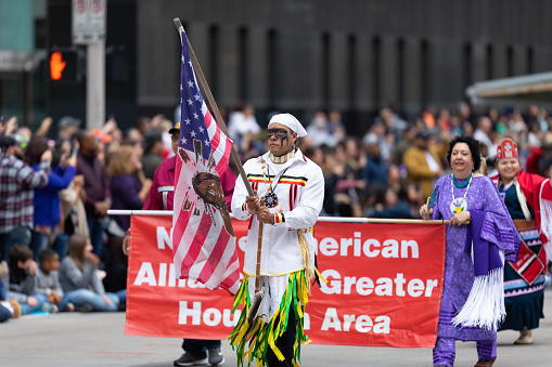 Houston, Texas, USA - November 28, 2019: H-E-B Thanksgiving Day Parade, Members of the Native American Alliance Greater Houston Area, wearing traditional clothing at the parade