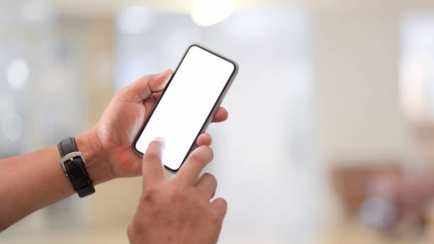 istock Close-up view of businessman using blank screen smartphone 1203666346
