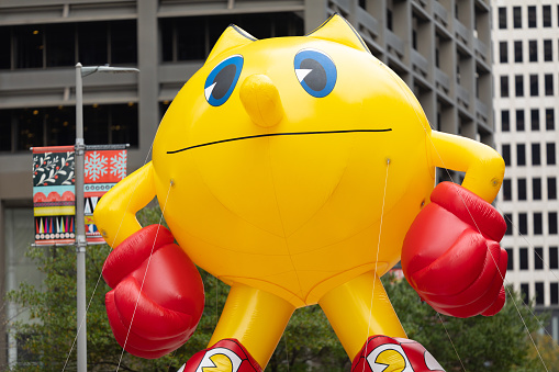 Houston, Texas, USA - November 28, 2019: H-E-B Thanksgiving Day Parade, large balloon in the shape of pac-man going down Milam Street during the parade