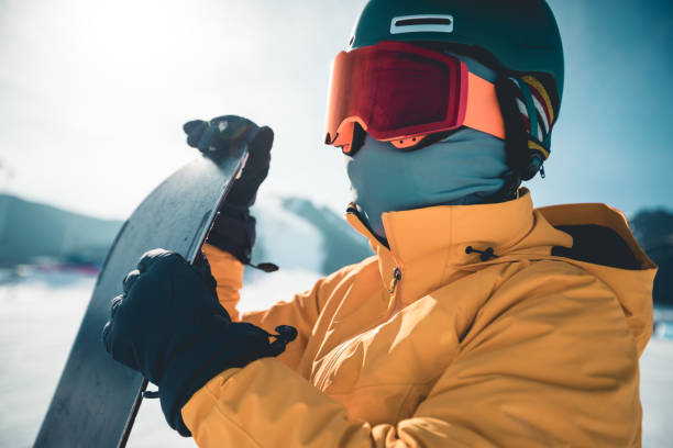 istock One snowboarder with snowboard on winter mountain top 1203671911