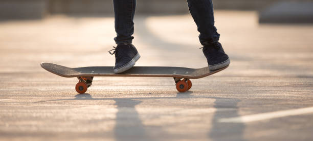 istock Skateboarder skateboarding at sunrise park 1203672042