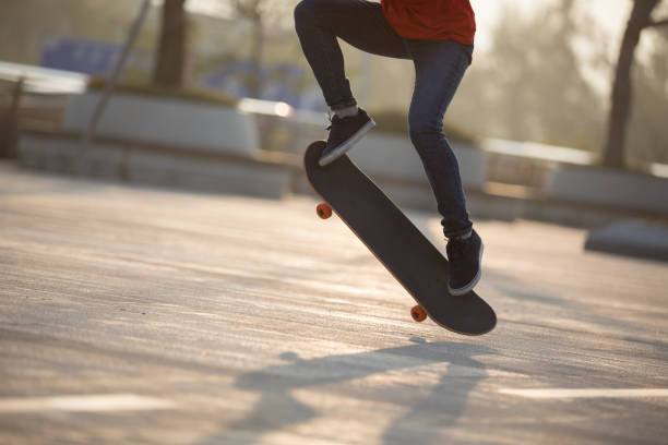 istock Skateboarder skateboarding at sunrise park 1203672146