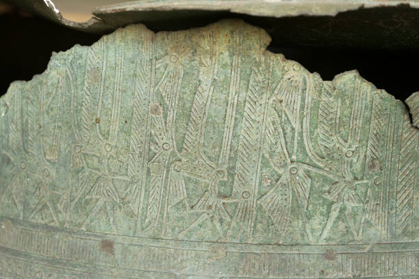istock Primitive art craving on surface of ancient bronze drum. 1203672990