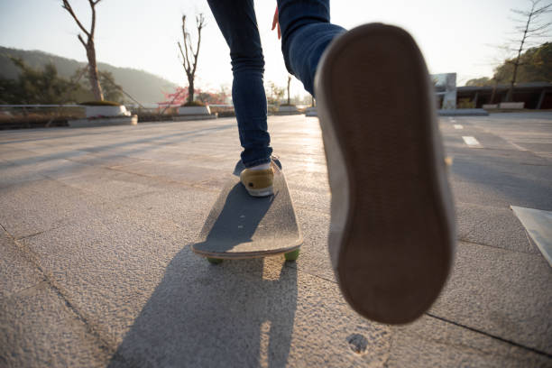 istock Skateboarder skateboarding at sunrise park 1203673163