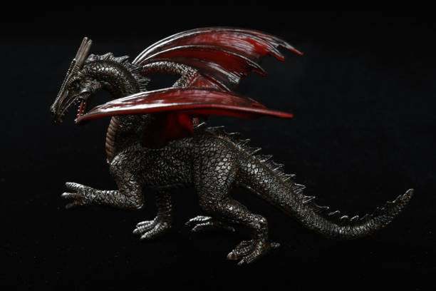 istock toy dinosaur with wings on a dark background 1203673196
