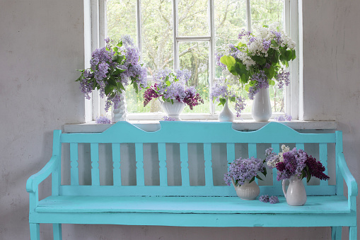 rustic interior with lilac flowers in vases