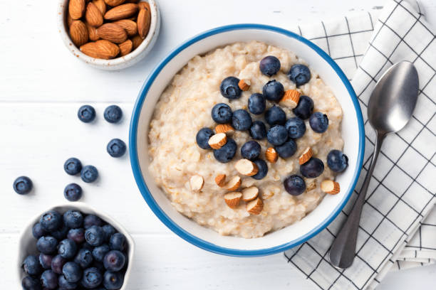 istock Breakfast oatmeal porridge bowl with almonds and blueberries 1203675599