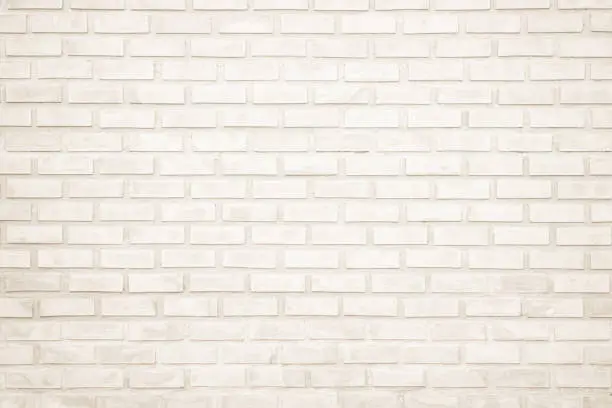 Photo of Background of wide cream brick wall texture. Old brown brick wall concrete or stone wall textured, wallpaper limestone abstract flooring/Grid uneven interior rock. Home or office design backdrop.
