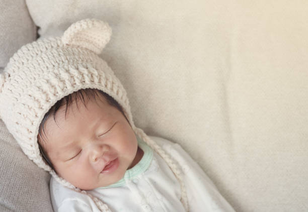 istock Closeup a baby sleeping comfortably on sofa with copy space 1203678597