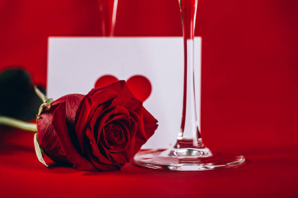 istock Valentines day background with champagne glasses and red rose 1203679478