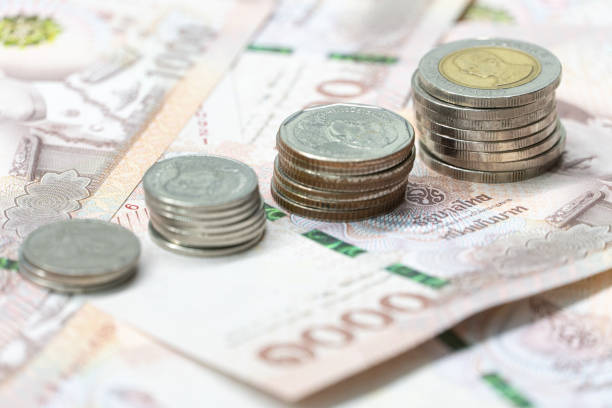 istock Close up bar chart from coin on Thai Bath currency money banknote. 1203680321