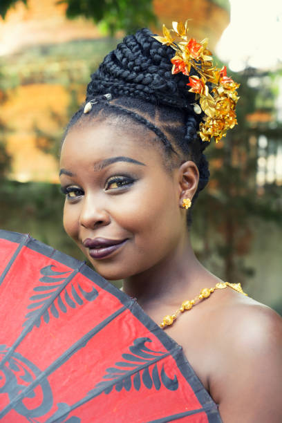 istock African woman holding red umbrella 1203680432