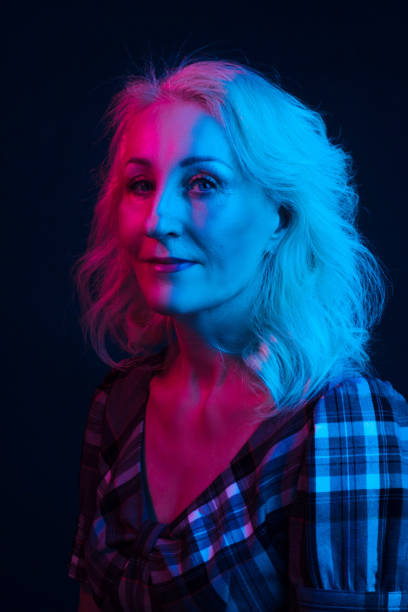 istock Portrait old woman in colorful bright lights . 1203681299