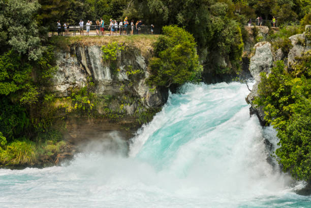 Huka Falls, Taupo - New Zealand Lake Taupo drains through a narrow gorge over the 11m Huka Falls into the Waikato River. They are a major tourist attraction. waikato river stock pictures, royalty-free photos & images
