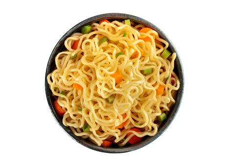 Instant noodles, isolated on a white background with a clipping path. Vegetable soba bowl with carrot and scallions, shot from the top