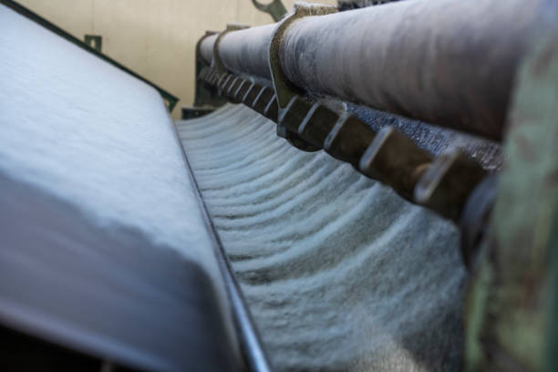 Close up detail of machine in textile factory working in recycled plastic and making  textile.