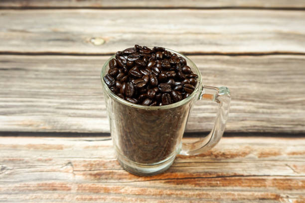 istock Dark roasted Arabica coffee  beans in cup 1203688814