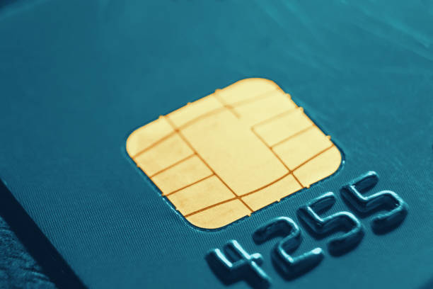 istock Micro credit card chip close-up, soft focus. New technologies, EMV chip card, smart payment cards. 1203688927