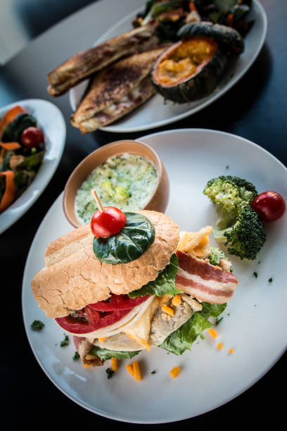 istock Loaded sandwich breakfast with bacon and vegetables with broccoli soup. 1203691131